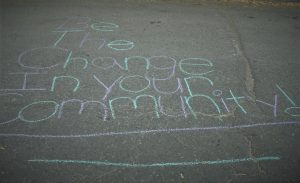 chalk art: "be the change in your community"